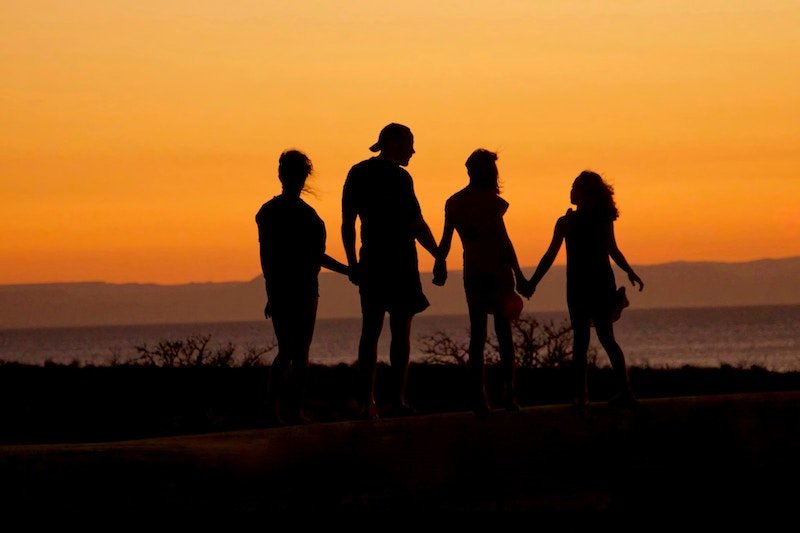 happy family on the beach in shadows