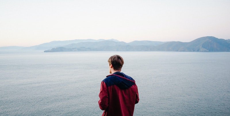 man looking at water