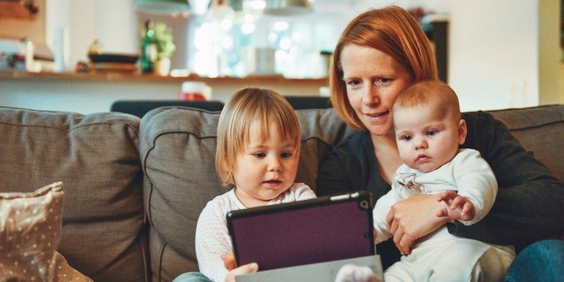 Mom holding tablet with babies