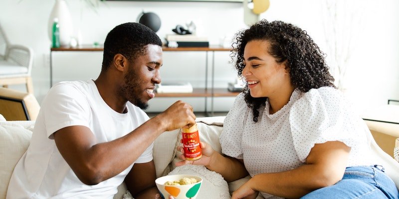 couple eating on couch