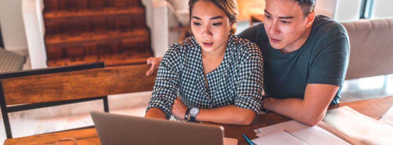 YNAB Review - Couple looking at budget together