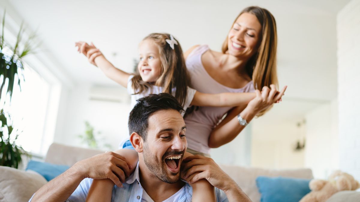 Happy family with kid on dads shoulders