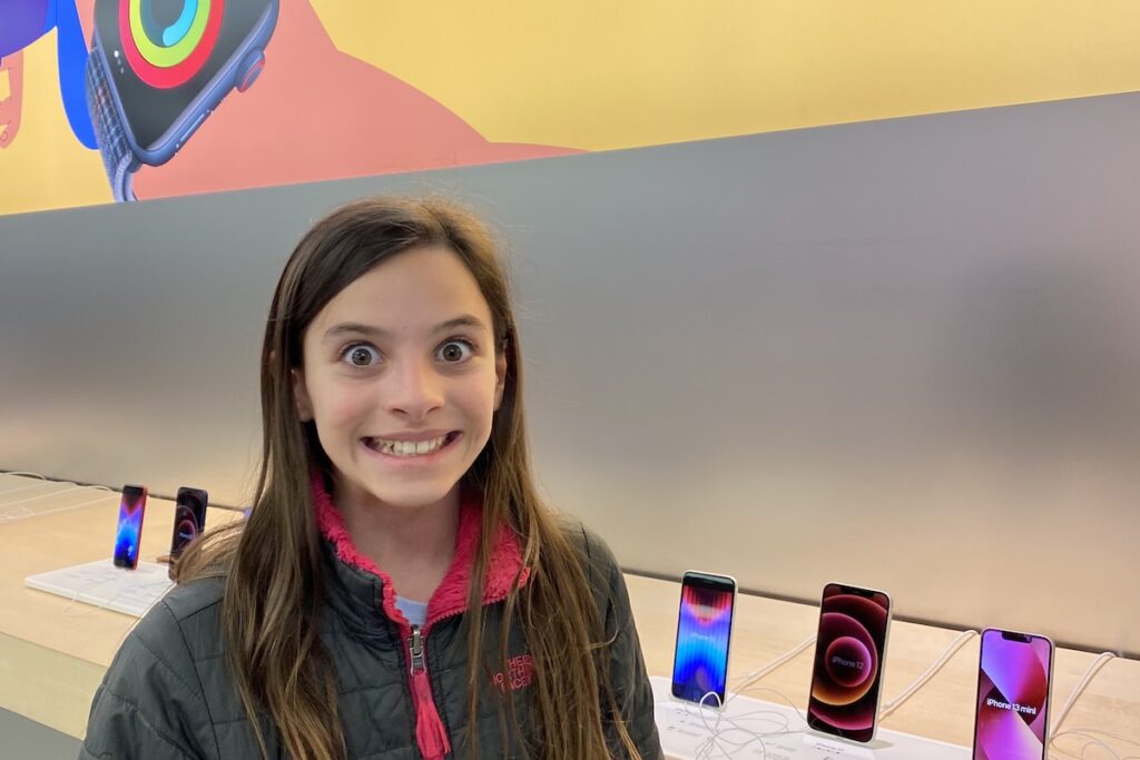 11-year-old girl with her first iPhone purchased with money she saved herself