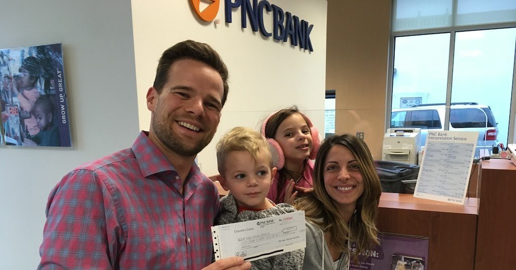 Andy and Nicole Hill at the bank after making their final mortgage payment.